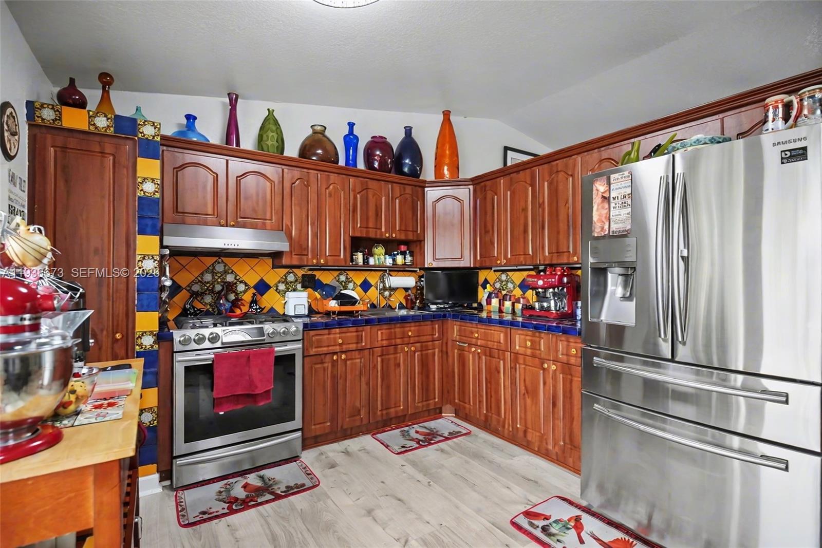 13574 Southwest 49th Lane Miami, FL 33175 - Photo 9 of 36 a kitchen with stainless steel appliances granite countertop a refrigerator and a wooden cabinets