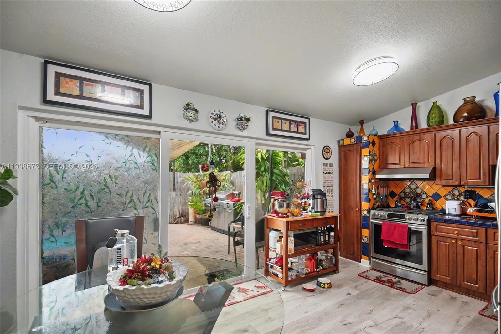 13574 Southwest 49th Lane Miami, FL 33175 - Photo 10 of 36 a living room with lots of furniture and a fireplace