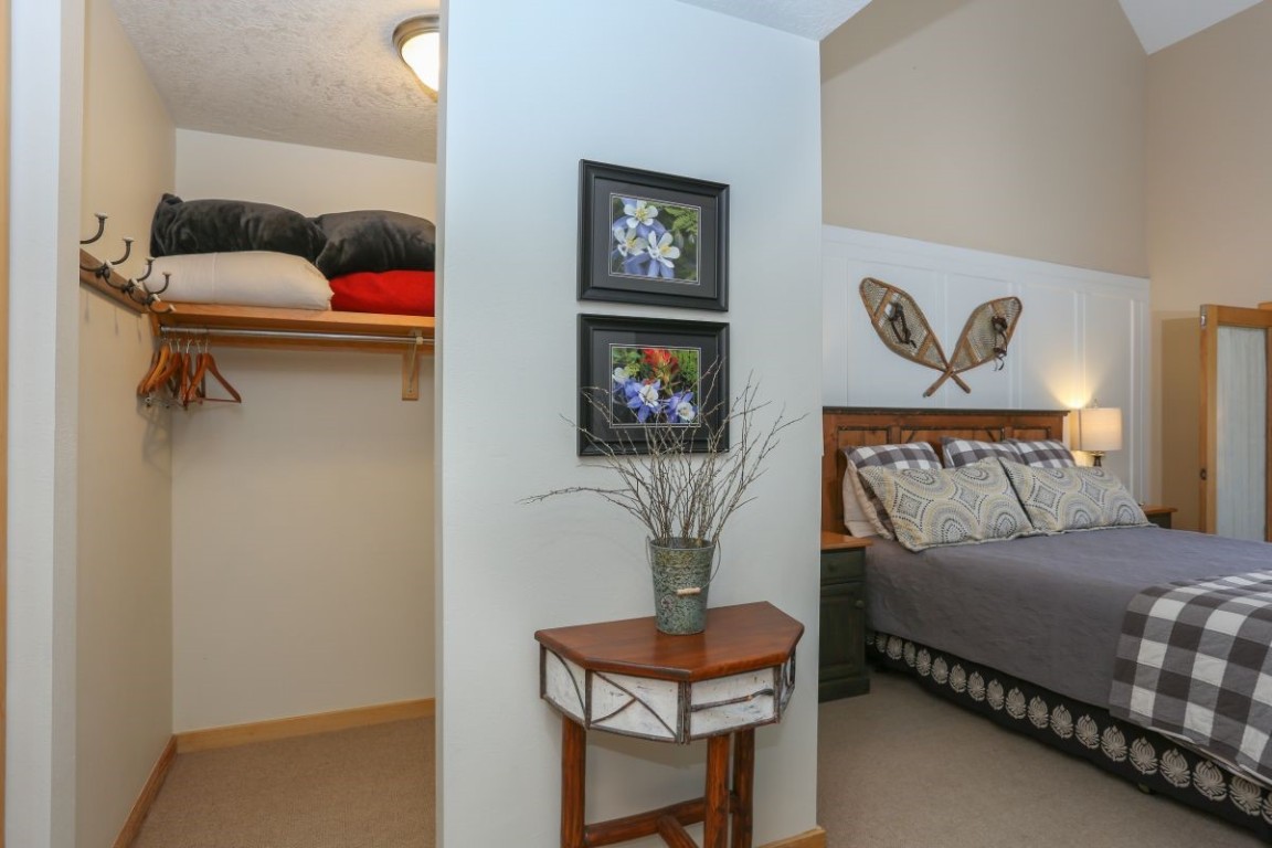 21680 Highway 6, Unit 2058 Keystone, CO 80435 - Photo 14 of 33 a bedroom with a bed and wooden floor