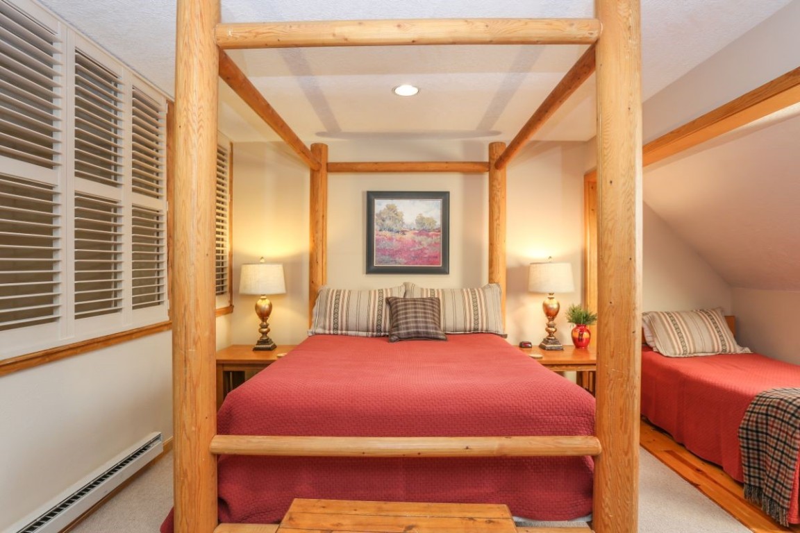 21680 Highway 6, Unit 2058 Keystone, CO 80435 - Photo 19 of 33 a bedroom with a bed and wooden floor