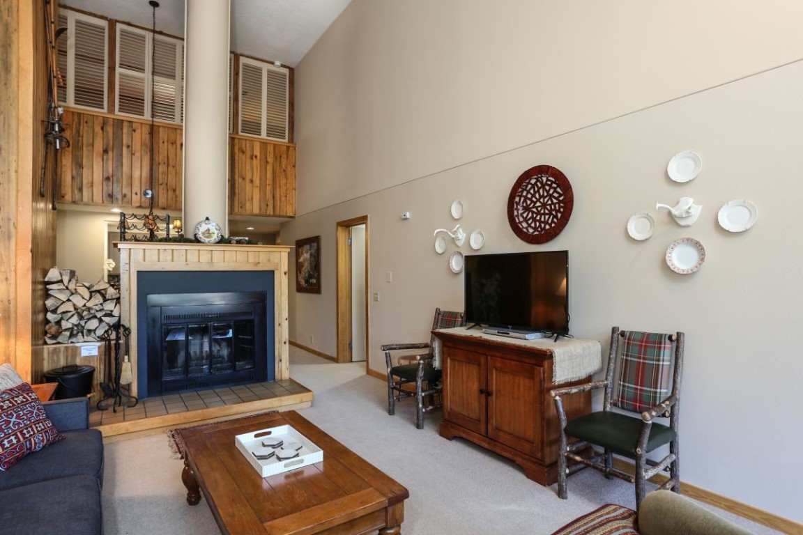 21680 Highway 6, Unit 2058 Keystone, CO 80435 - Photo 4 of 33 a living room with furniture a fireplace and a flat screen tv