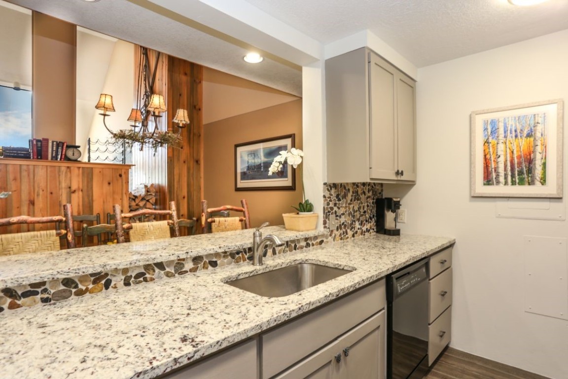21680 Highway 6, Unit 2058 Keystone, CO 80435 - Photo 6 of 33 a bathroom with a granite countertop sink a mirror and next to a window