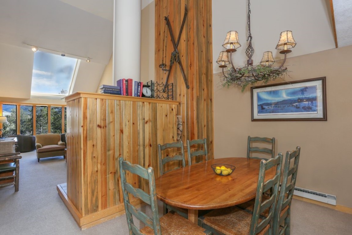 21680 Highway 6, Unit 2058 Keystone, CO 80435 - Photo 9 of 33 a dining room with furniture and a chandelier