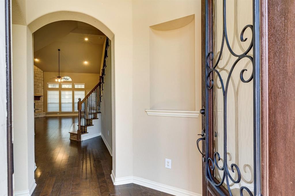 1522 Blue Jay Road Garland, TX 75043 - Photo 4 of 32 Ornate front door with decorative ironwork, opening to an arched entryway