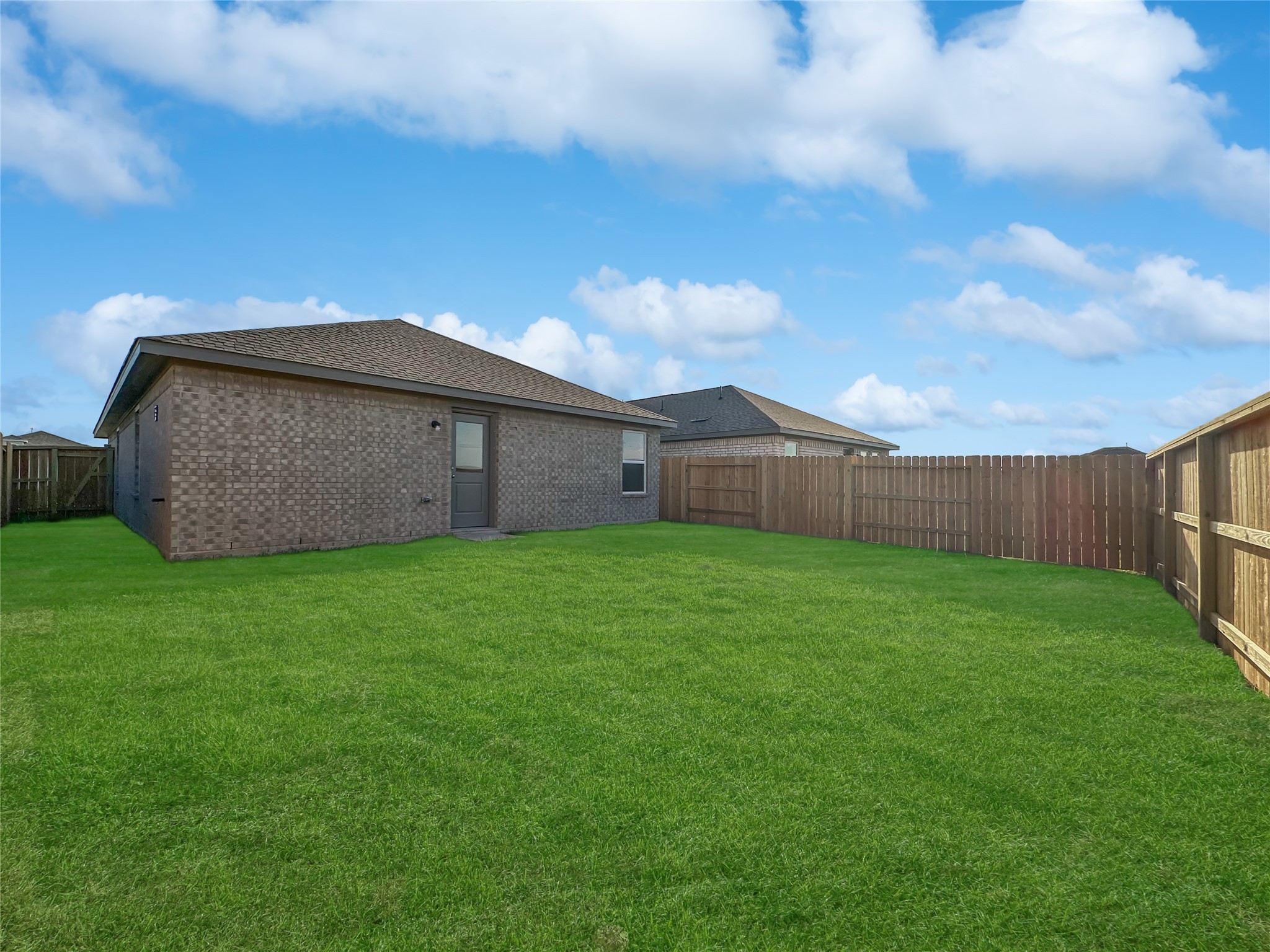 1715 Windrose Bend Angleton, TX 77515 - Photo 19 of 26 a view of a backyard with potted plants and wooden fence
