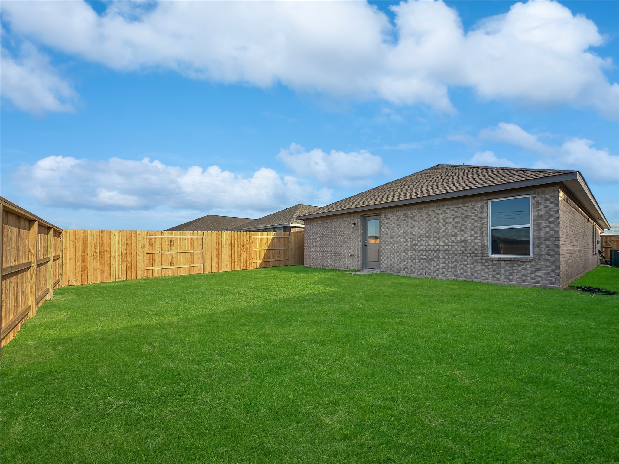 1715 Windrose Bend Angleton, TX 77515 - Photo 20 of 26 a backyard of a house with lots of green space