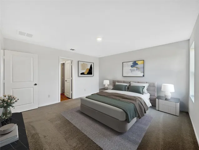 a spacious bedroom with a bed and a couch