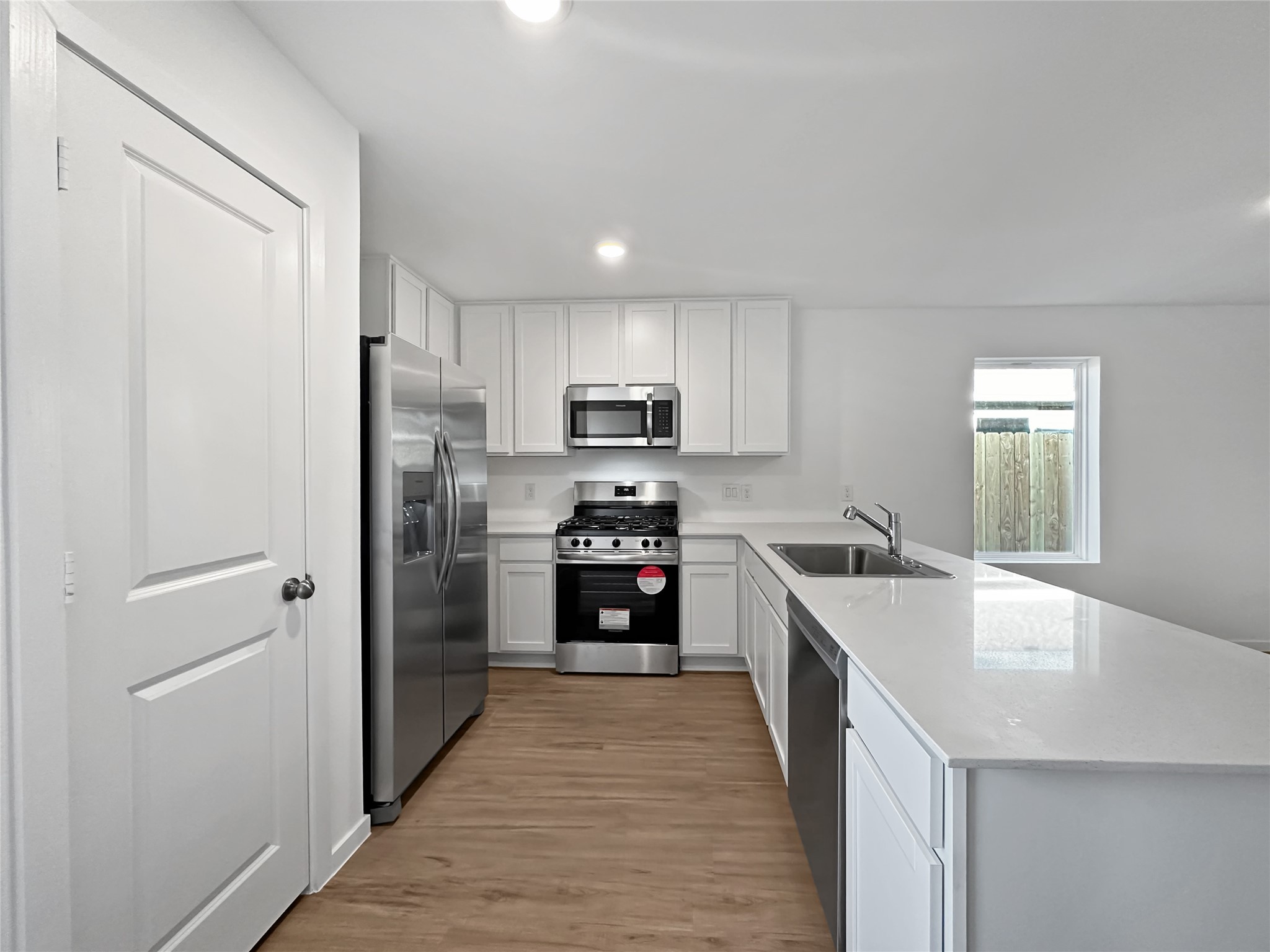 1715 Windrose Bend Angleton, TX 77515 - Photo 6 of 26 a kitchen with stainless steel appliances granite countertop a refrigerator and a sink