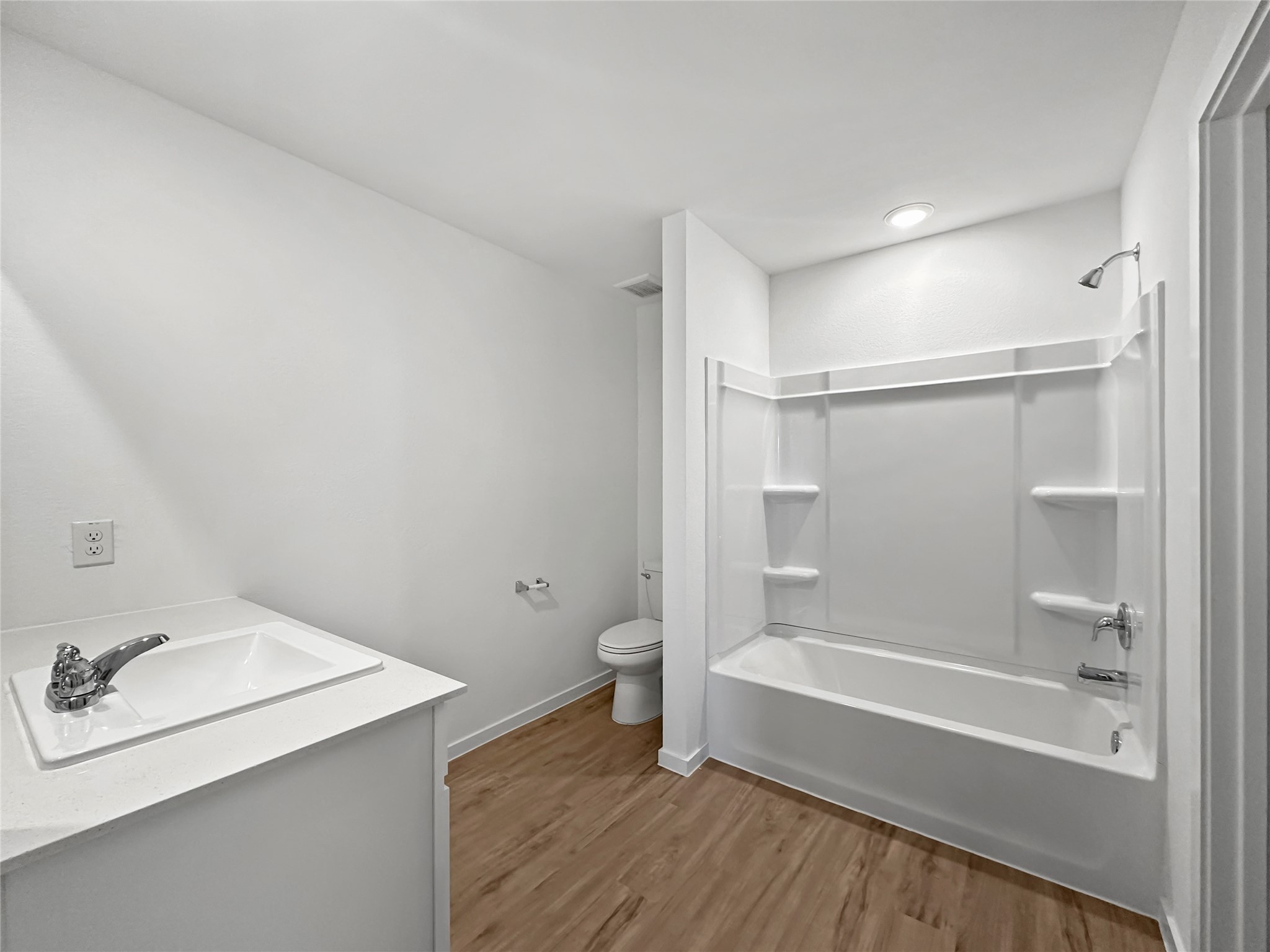 1715 Windrose Bend Angleton, TX 77515 - Photo 9 of 26 a bathroom with a bathtub shower sink vanity and a toilet