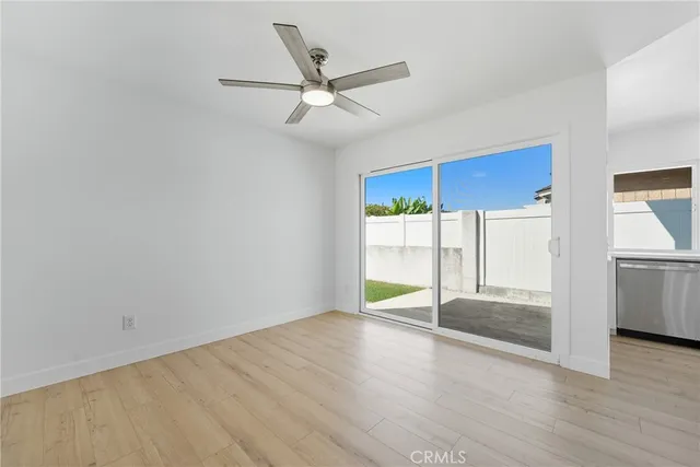 a view of a livingroom with a ceiling fan and wooden floor