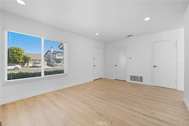 a big room with wooden floor and windows