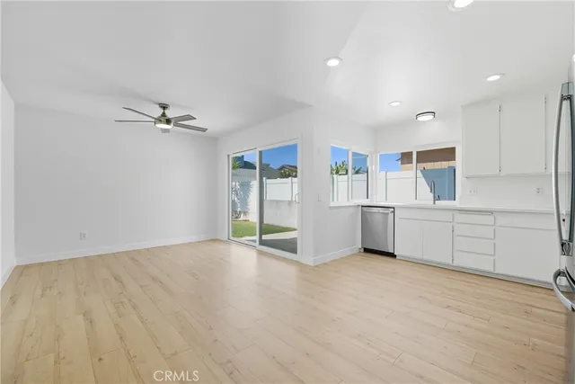 a view of a kitchen with furniture and wooden floor