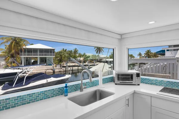 a kitchen with a sink and a refrigerator