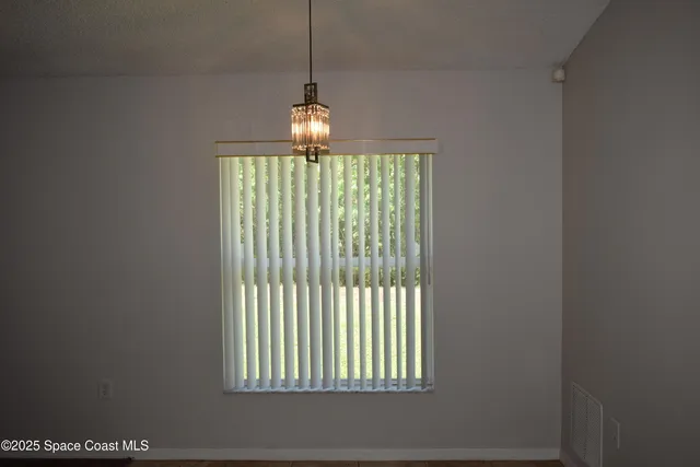 a view of a room with a ceiling fan and a window