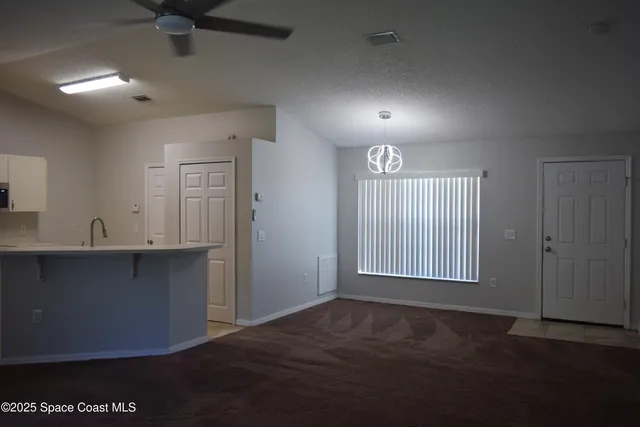 an empty room with windows and closet