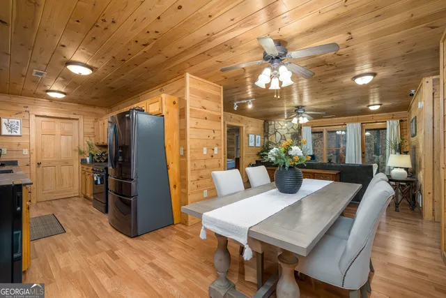 a living room with furniture a fireplace and a chandelier