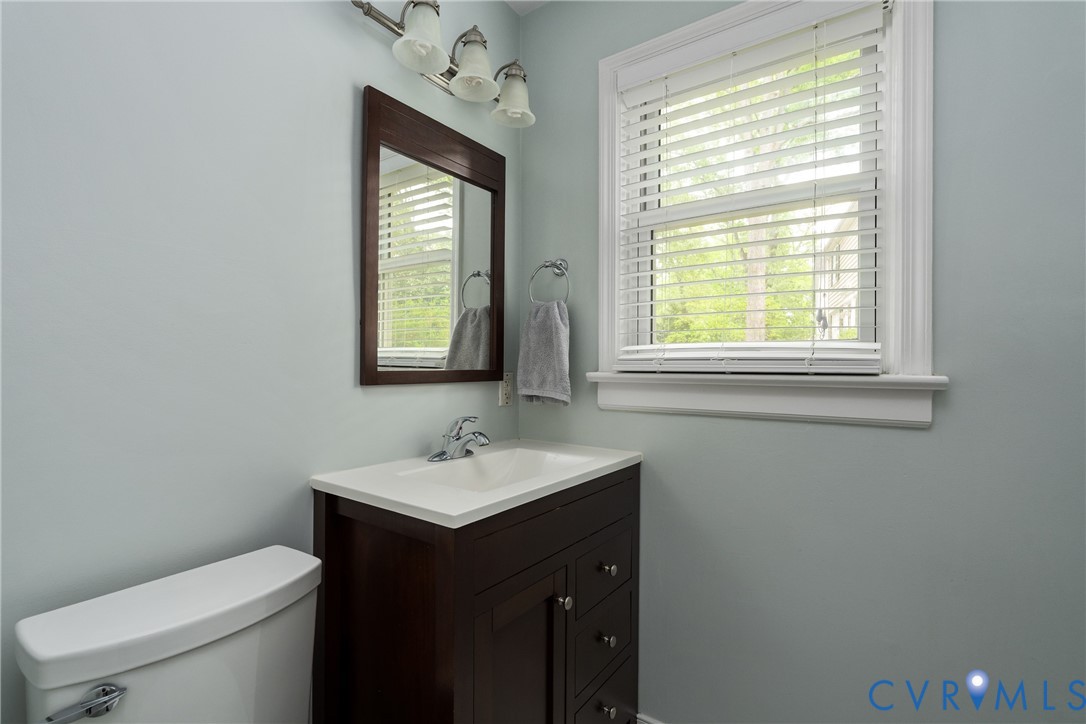 5414 New Kent Road Richmond, VA 23225 - Photo 28 of 62 a bathroom with a toilet sink vanity and mirror