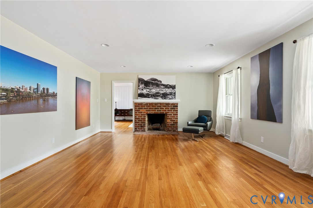 5414 New Kent Road Richmond, VA 23225 - Photo 9 of 62 a view of a livingroom with a fireplace a chandelier and wooden floor