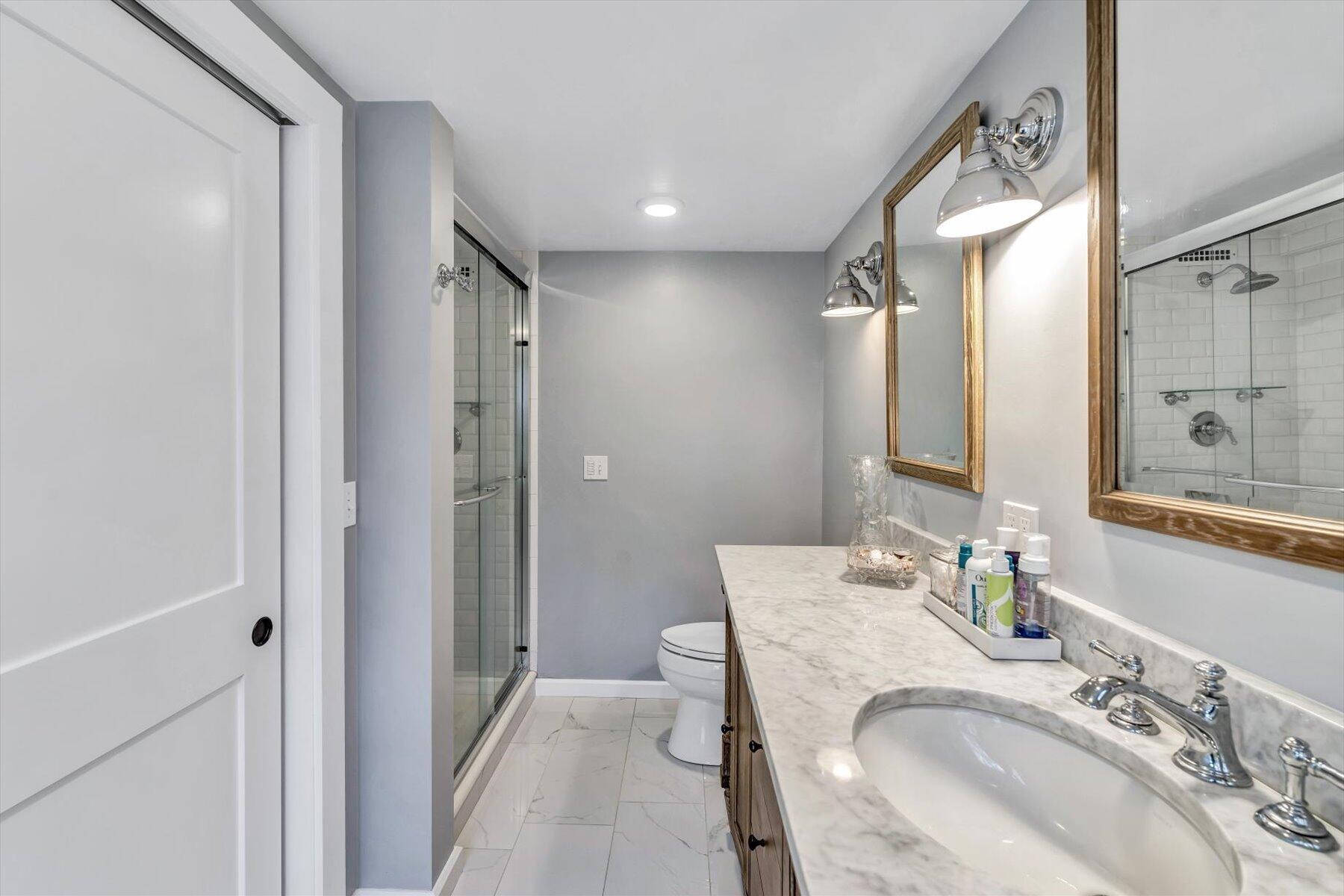 15 Greensward Road Mashpee, MA 02649 - Photo 15 of 27 a bathroom with a granite countertop sink double vanity and a mirror