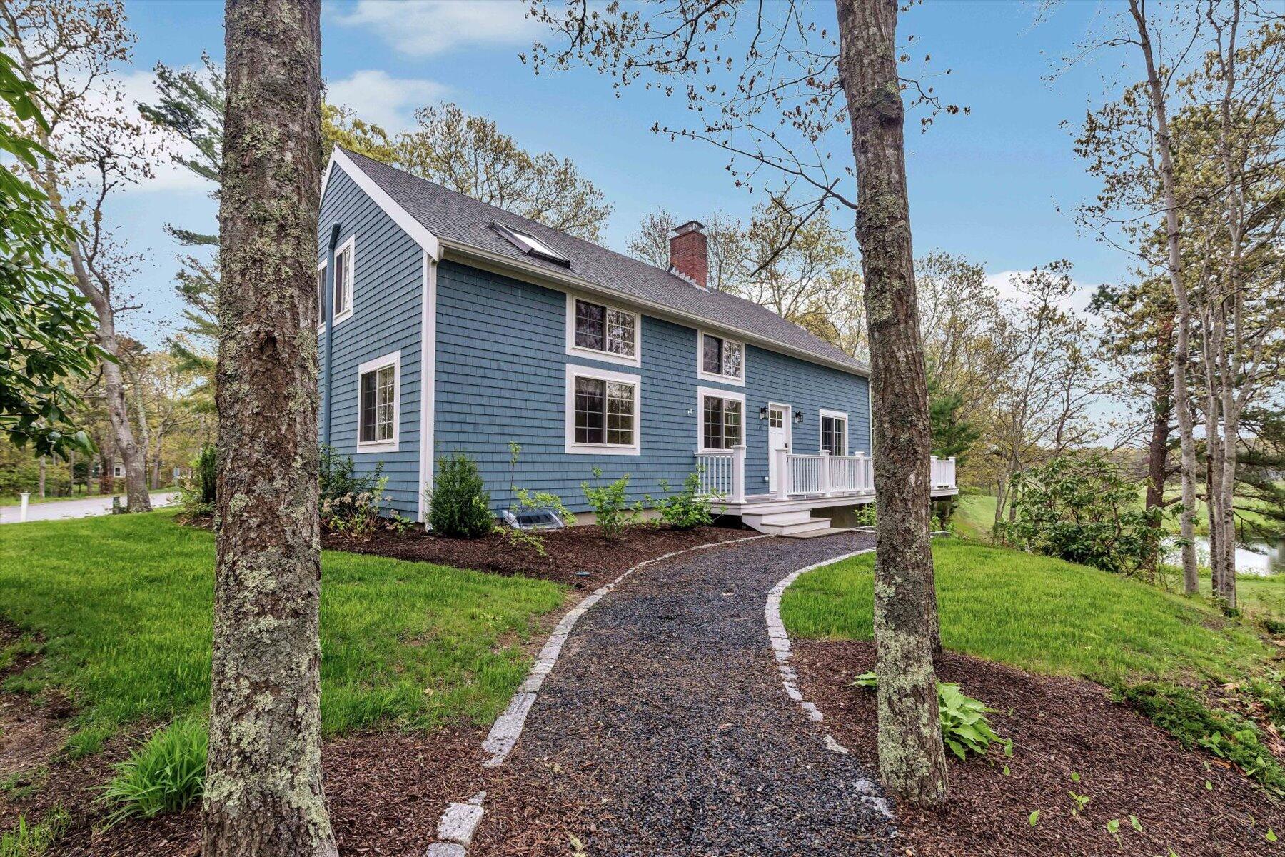 15 Greensward Road Mashpee, MA 02649 - Photo 2 of 27 a front view of a house with garden