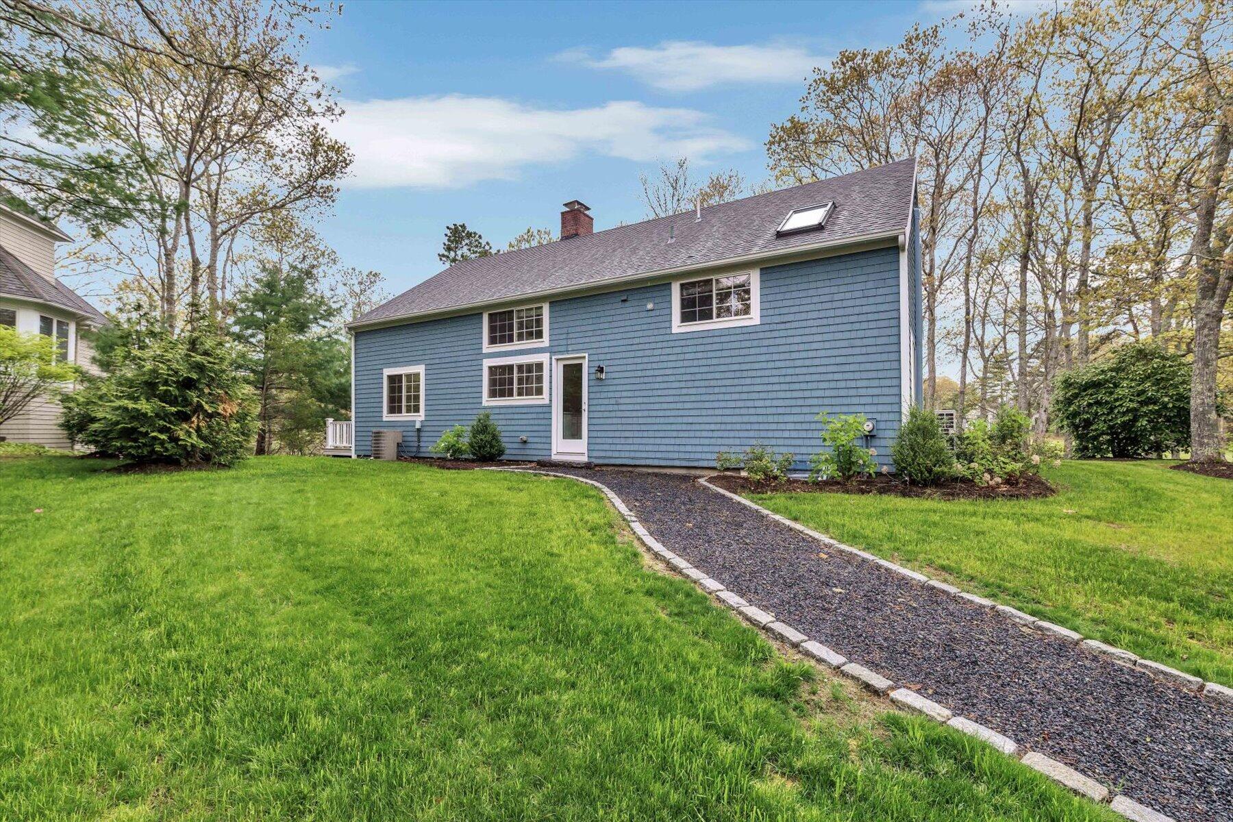 15 Greensward Road Mashpee, MA 02649 - Photo 22 of 27 a view of a house with yard and a garden