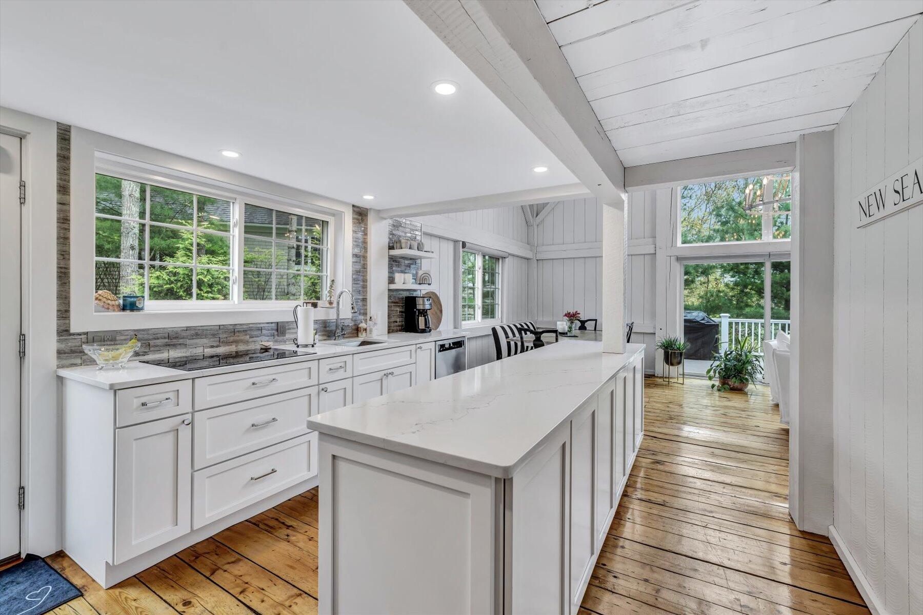 15 Greensward Road Mashpee, MA 02649 - Photo 8 of 27 a large kitchen with kitchen island a large window a sink and stainless steel appliances
