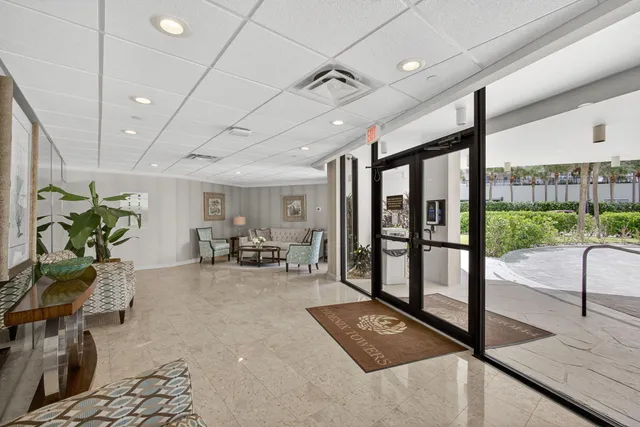 a view of a patio with table and chairs and potted plants