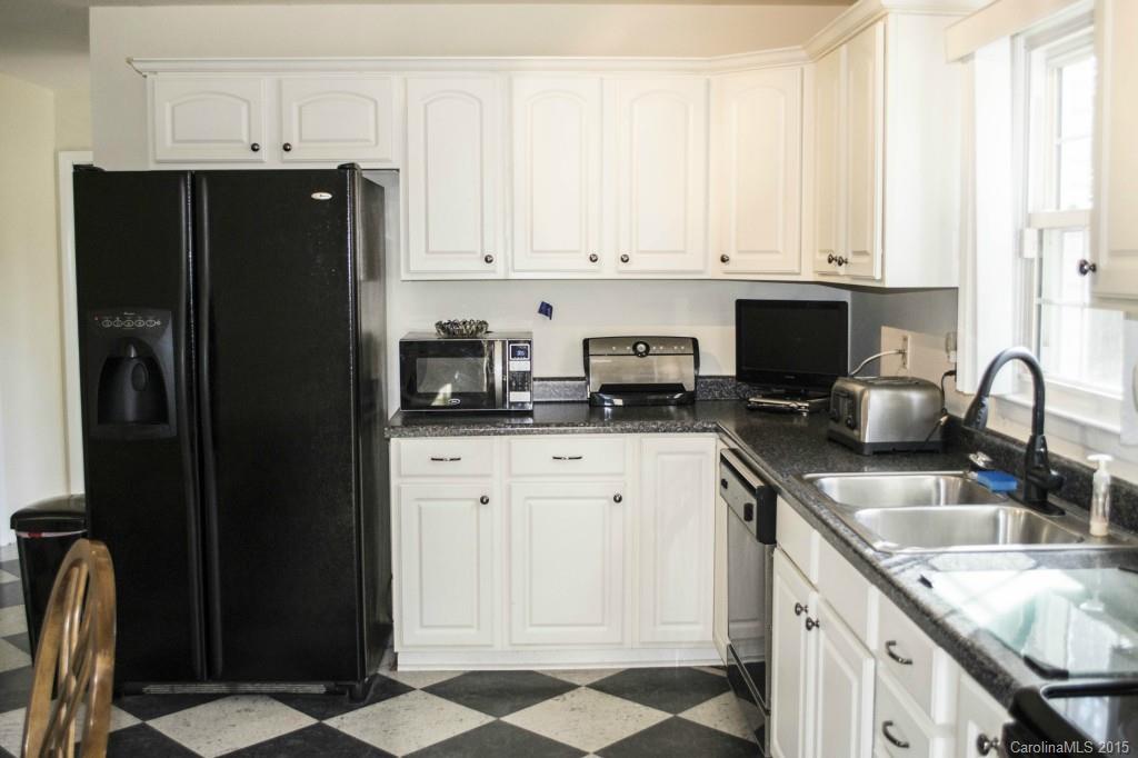 8710 Houston Ridge Road, Unit 21 Charlotte, NC 28277 - Photo 21 of 22 a kitchen with stainless steel appliances granite countertop a refrigerator sink and cabinets