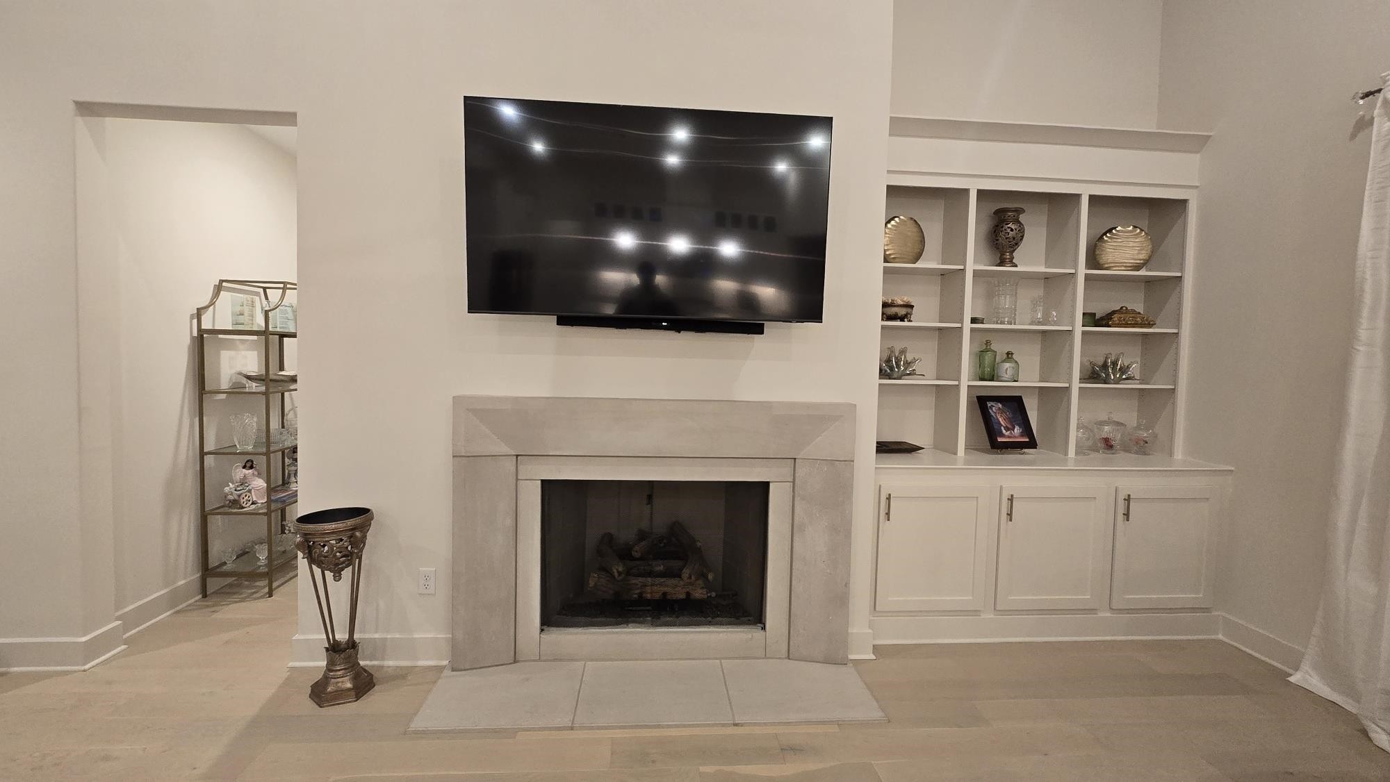 11200 Shelby Post Road Collierville, TN 38017 - Photo 11 of 29 a living room with a fireplace and a flat screen tv