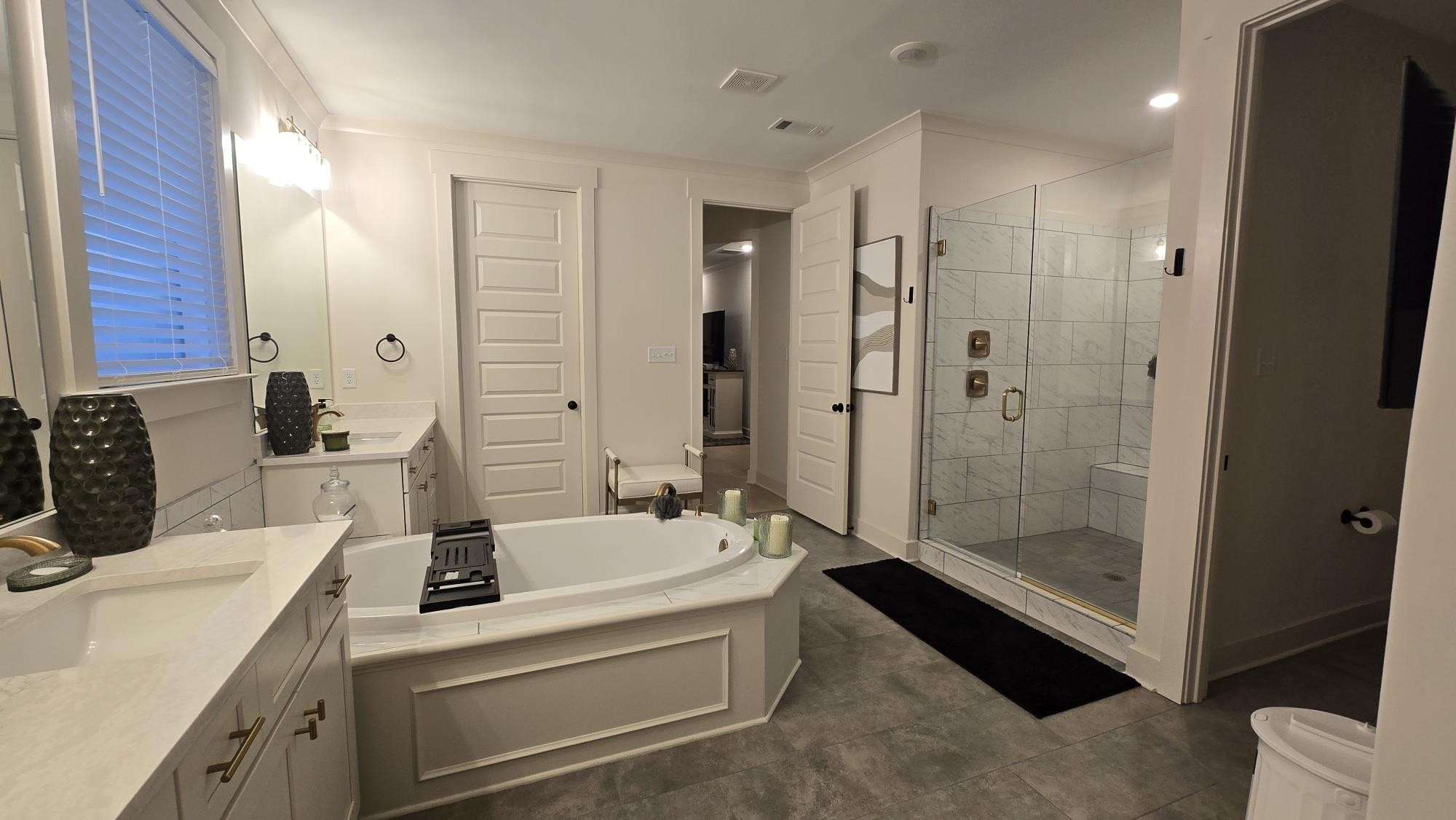 11200 Shelby Post Road Collierville, TN 38017 - Photo 8 of 29 a bathroom with a double vanity sink a toilet a mirror and shower