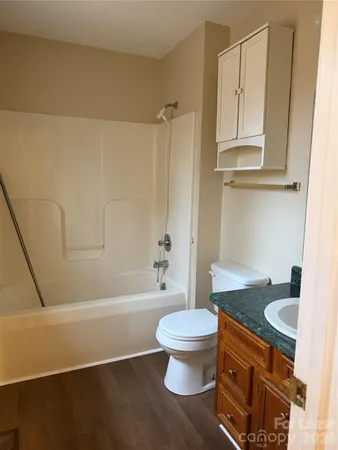 a bathroom with a toilet a sink and bathtub