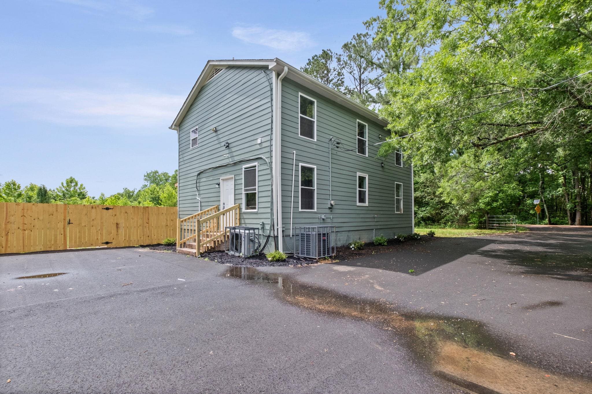 5843 Stewart Road Lakeland, TN 38002 - Photo 5 of 26 Two-story exterior with teal siding and white window trim
