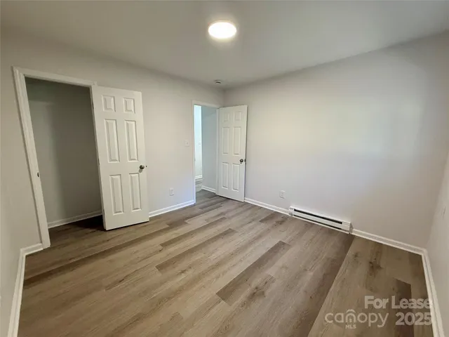 a view of a room with wooden floor