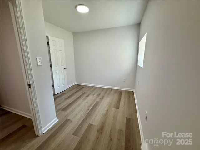 a view of a room with wooden floor