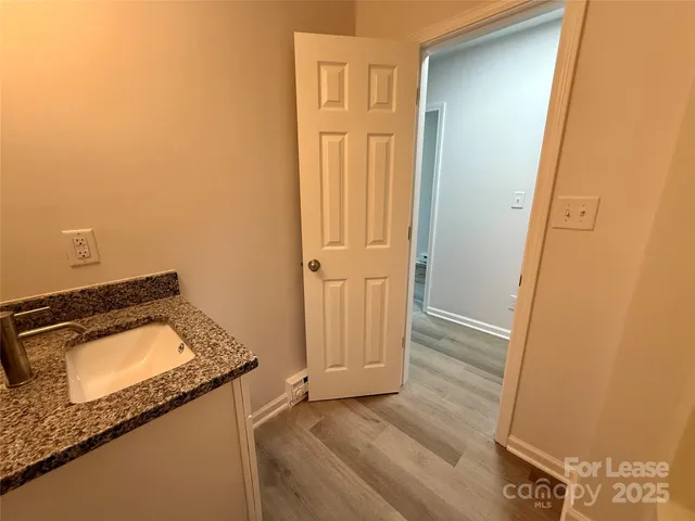 a bathroom with a granite countertop toilet a sink and a bathtub