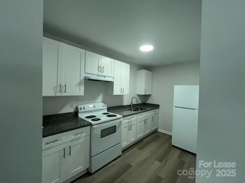 1902 West 5th Avenue, Unit B Gastonia, NC 28052 - Photo 24 of 25 a kitchen with granite countertop cabinets a sink and stainless steel appliances