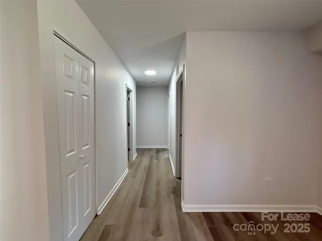 a view of hallway with wooden floor