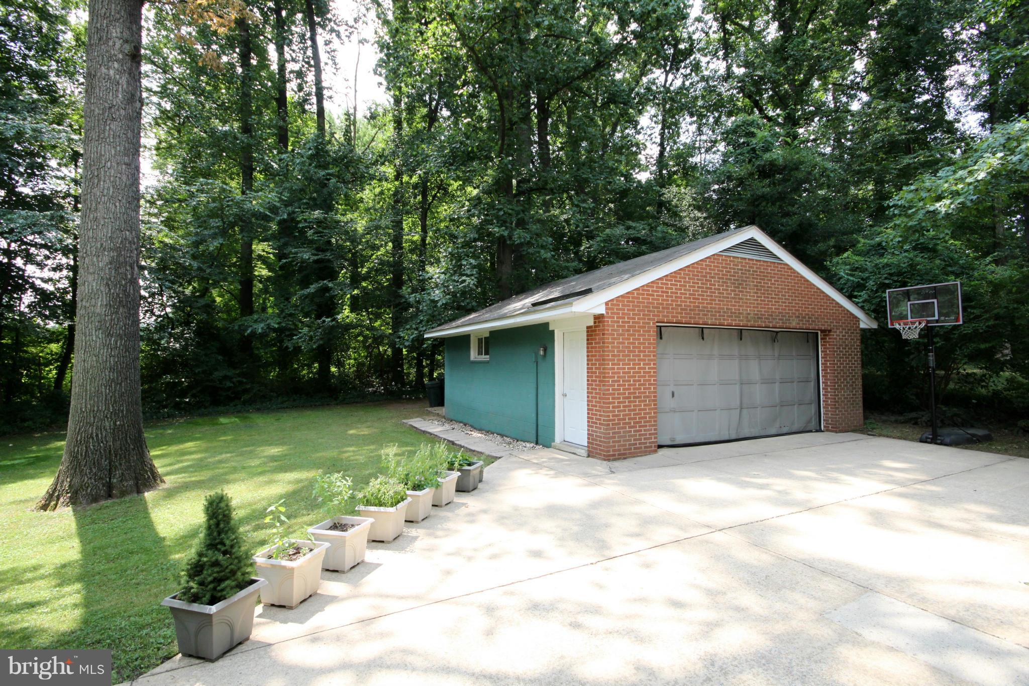 7531 Axton Street Springfield, VA 22151 - Photo 22 of 26 a front view of a house with a yard and garage