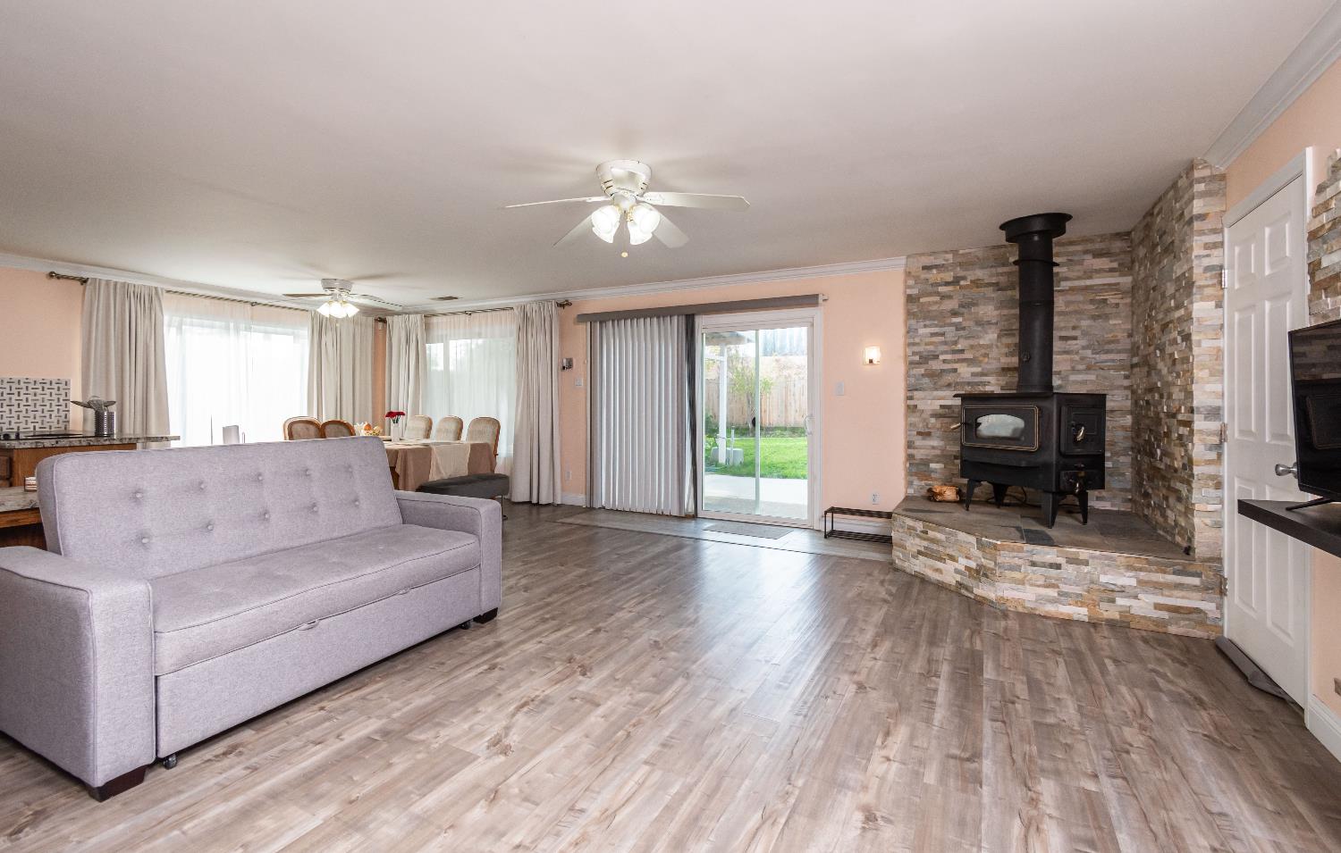 6851 Aleta Way Sacramento, CA 95842 - Photo 11 of 45 a living room with furniture and wooden floor