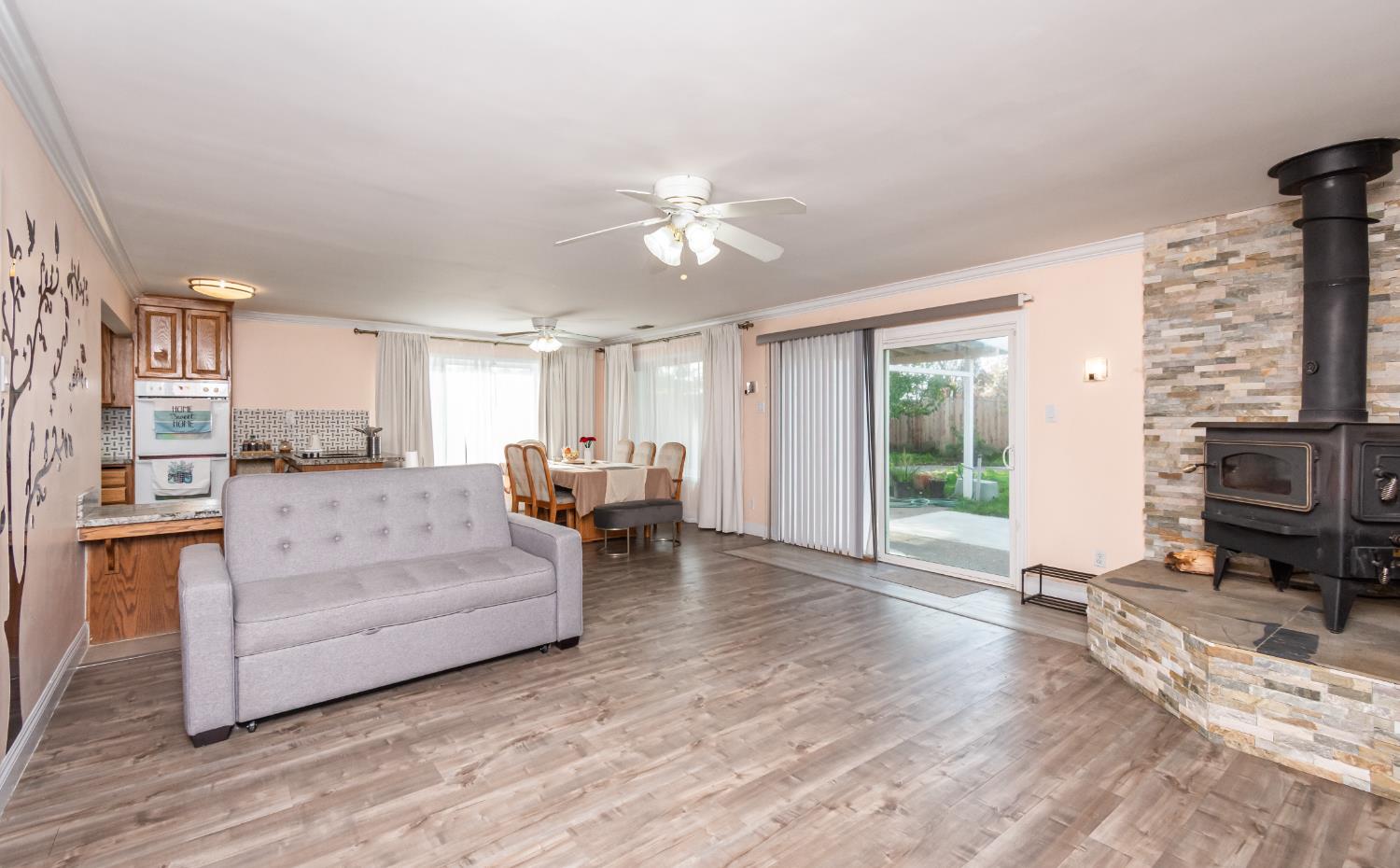6851 Aleta Way Sacramento, CA 95842 - Photo 12 of 45 a living room with furniture and a fireplace