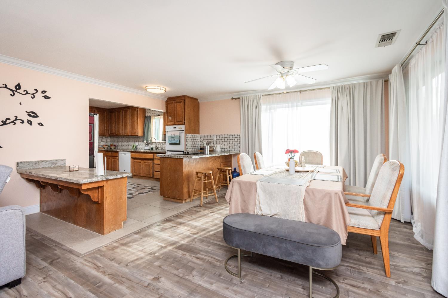 6851 Aleta Way Sacramento, CA 95842 - Photo 15 of 45 a living room with stainless steel appliances granite countertop furniture a fireplace a flat screen tv and a window