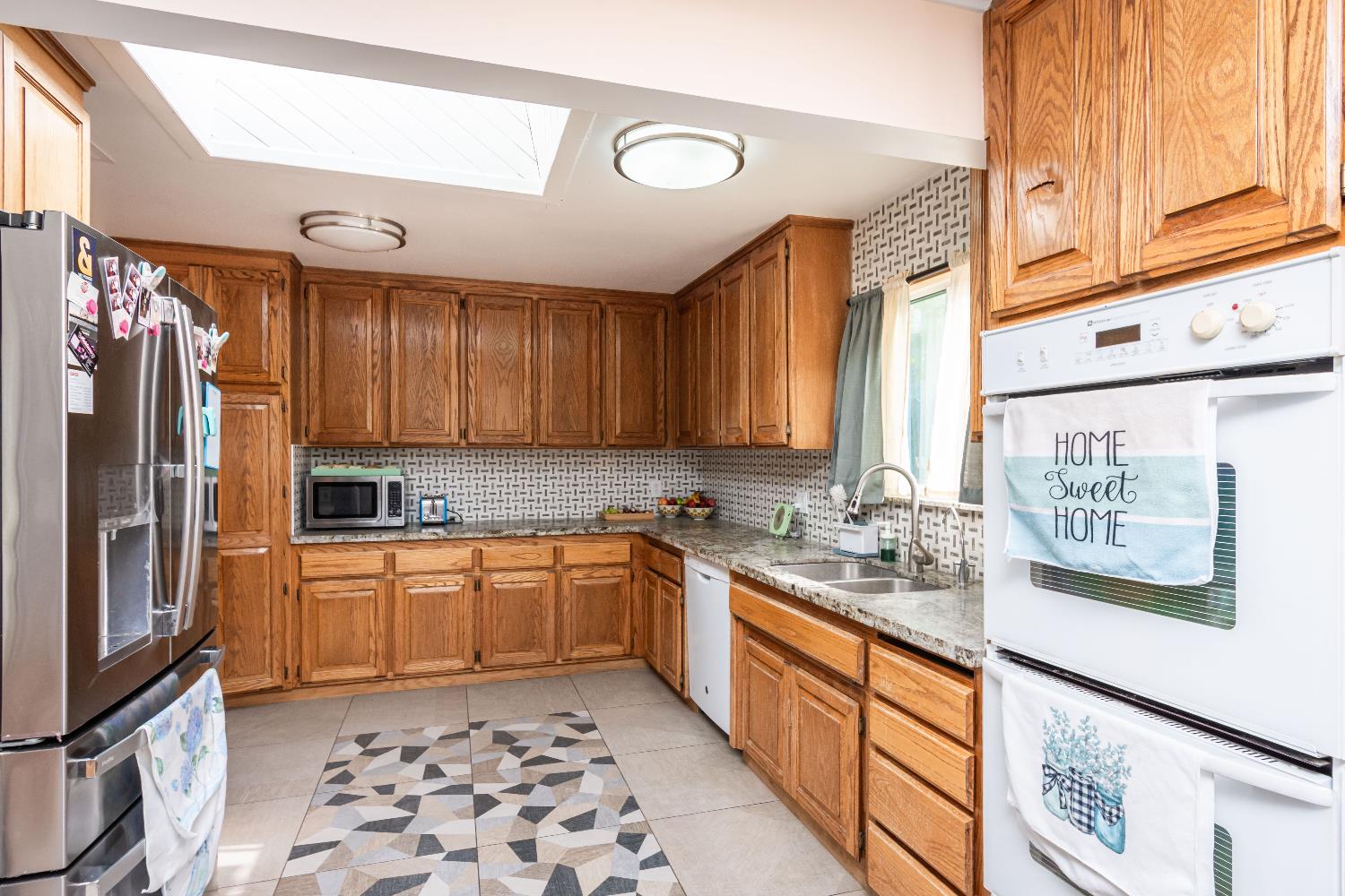 6851 Aleta Way Sacramento, CA 95842 - Photo 20 of 45 a kitchen with stainless steel appliances granite countertop a sink stove and refrigerator