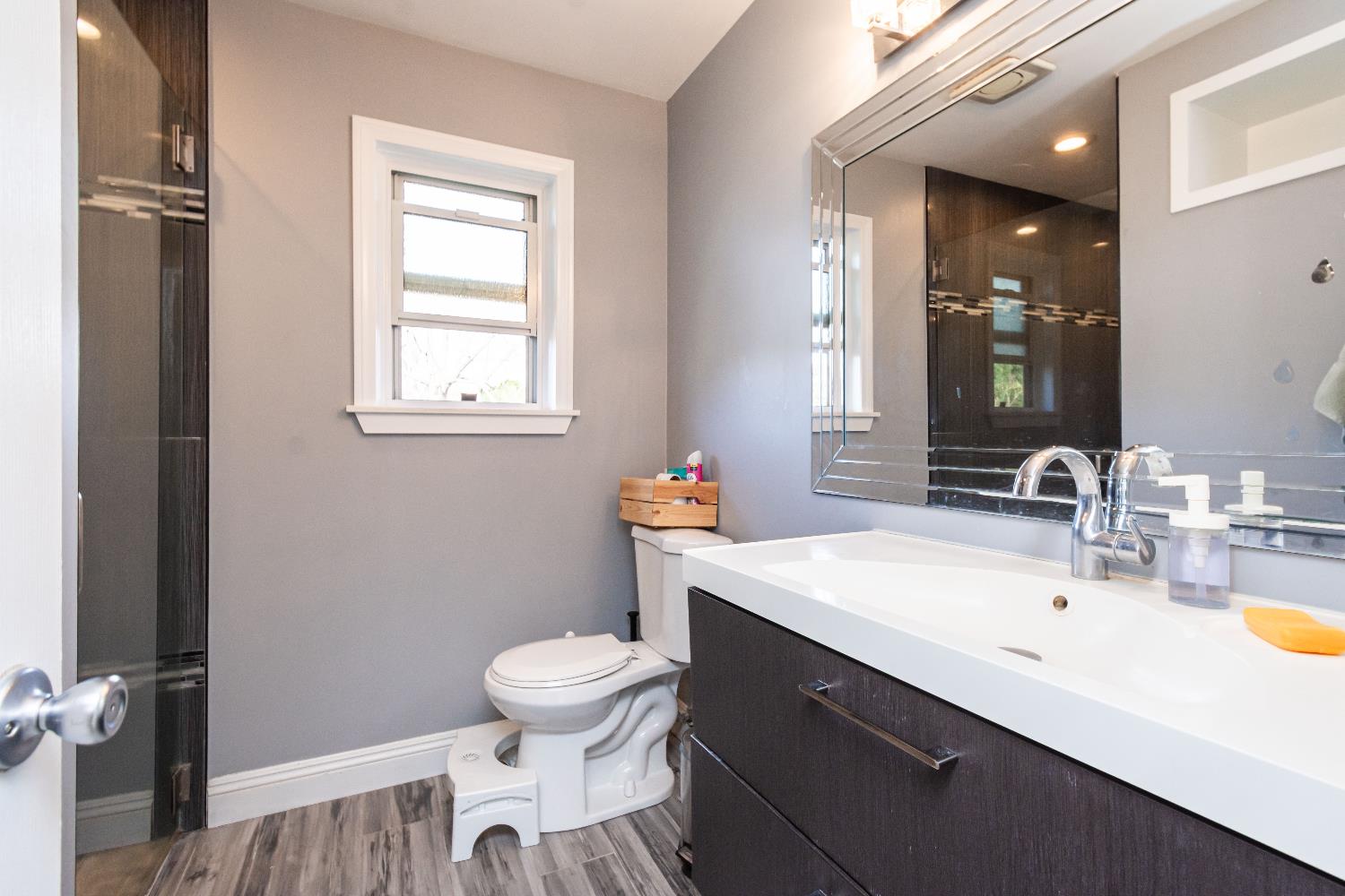 6851 Aleta Way Sacramento, CA 95842 - Photo 32 of 45 a bathroom with a sink a toilet and a mirror