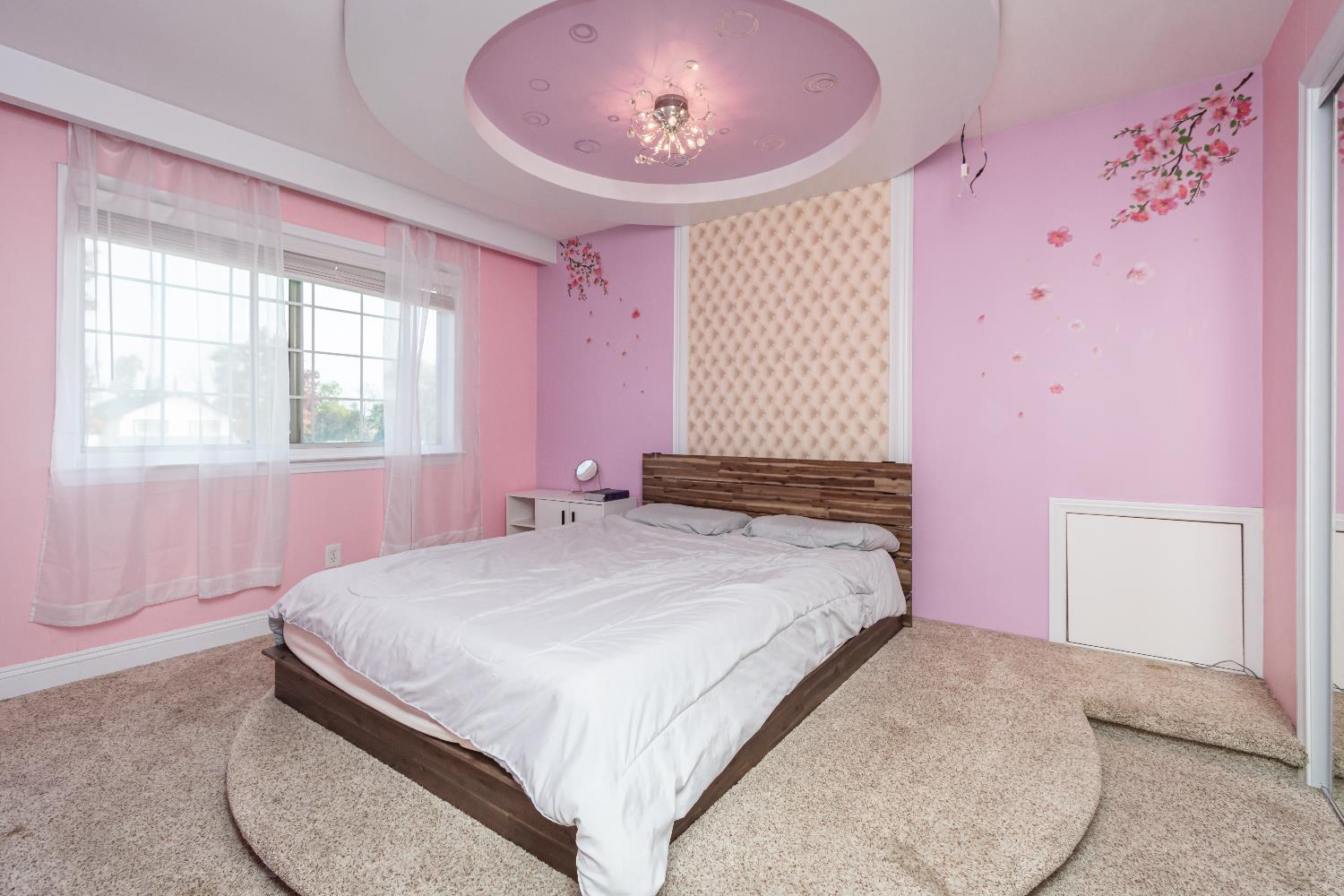 6851 Aleta Way Sacramento, CA 95842 - Photo 34 of 45 a bedroom with a bed and a chandelier