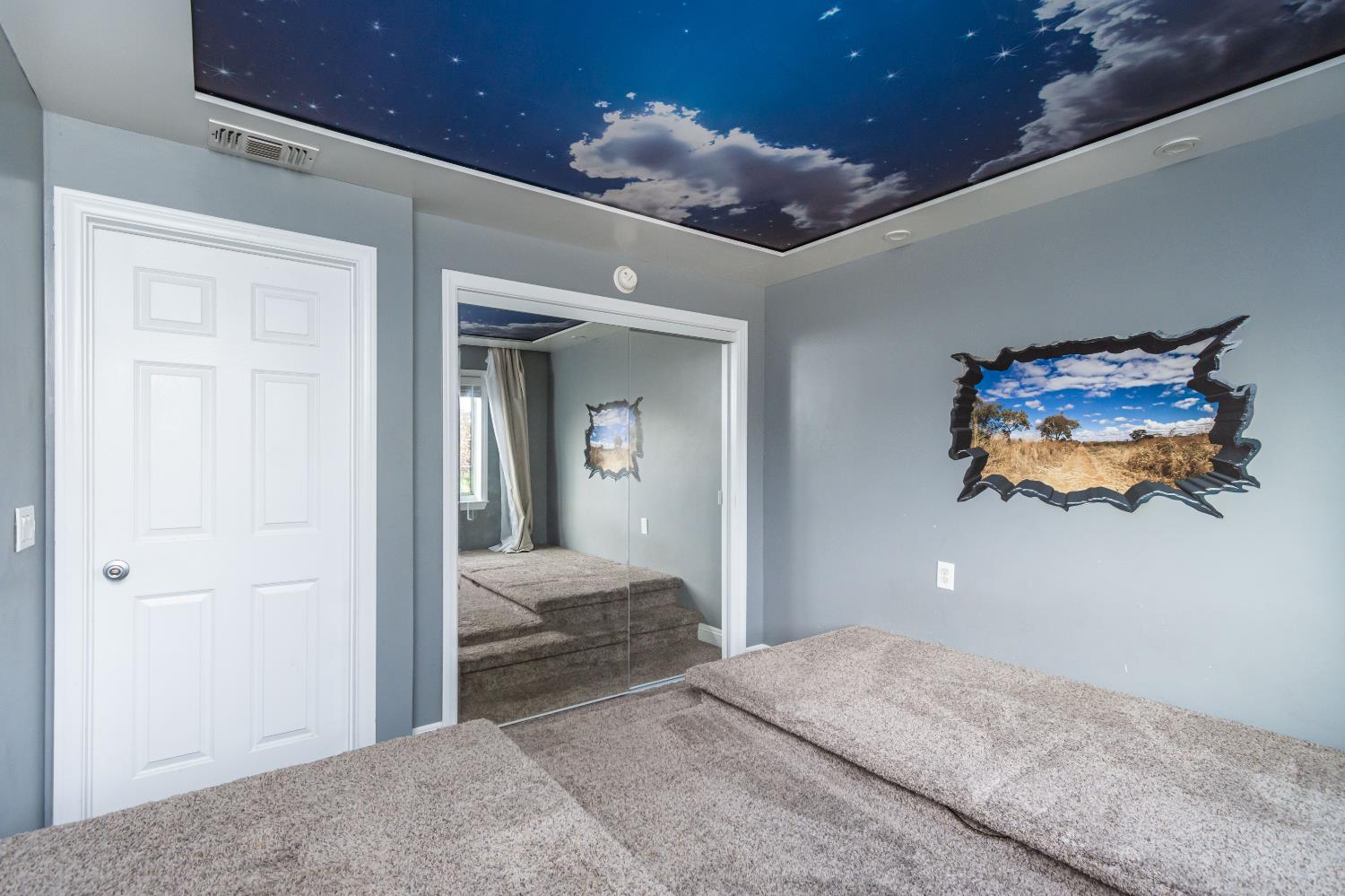 6851 Aleta Way Sacramento, CA 95842 - Photo 37 of 45 a bedroom with a bed and a chandelier