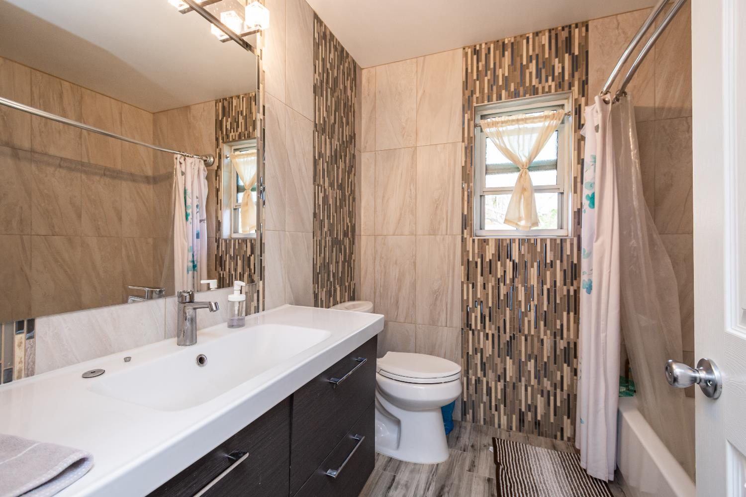 6851 Aleta Way Sacramento, CA 95842 - Photo 38 of 45 a bathroom with a sink a toilet and shower