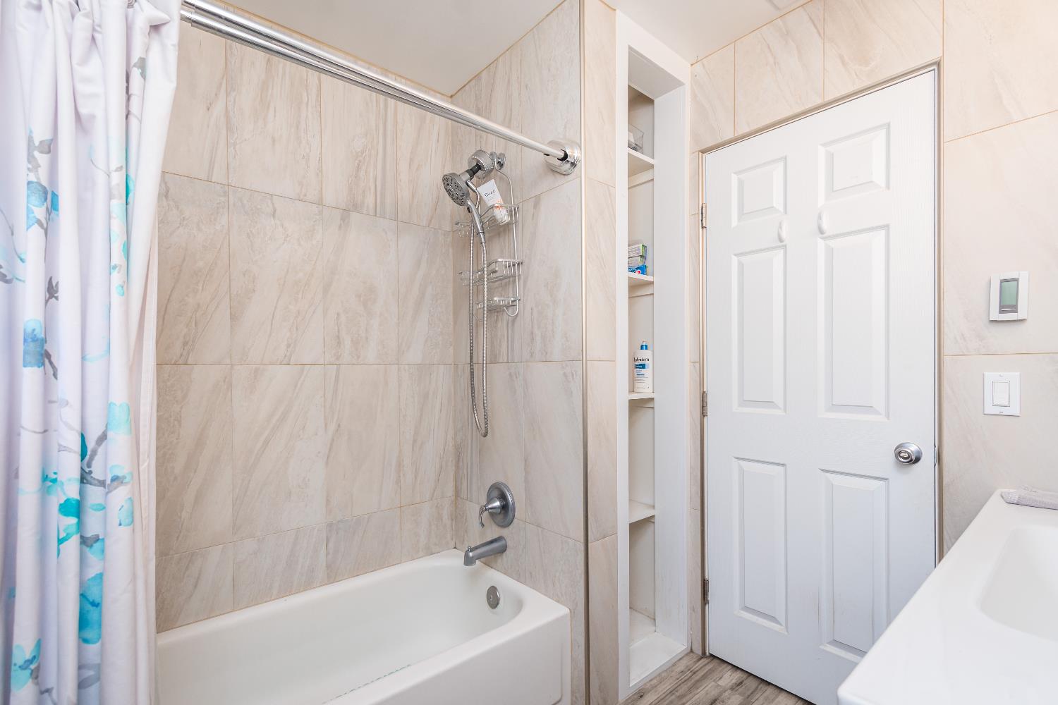 6851 Aleta Way Sacramento, CA 95842 - Photo 39 of 45 a bathroom with a shower and a bath tub