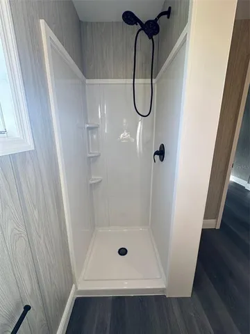 a white toilet sitting next to a shower