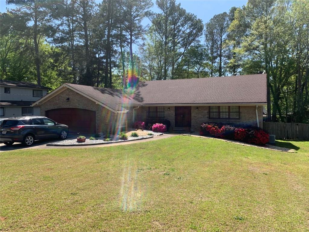 6305 Red Oak Road Atlanta, GA 30349 - Photo 1 of 1 a view of a house with swimming pool and a yard