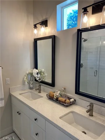 a bedroom with a large bed and a potted plant